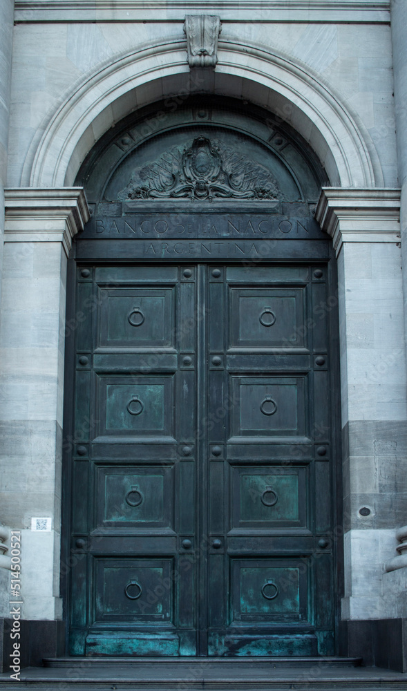 Heavy metalic double door outside of an old bank in buenos aires argentina. arch door frame. Heavy metalic double door outside of an old bank in buenos aires argentina. arch door frame.