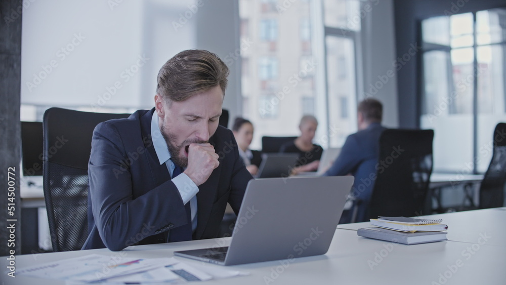 Sleepy manager yawning at computer in office, tired of overworking, burnout Sleepy manager yawning at computer in office, tired of overworking, burnout
