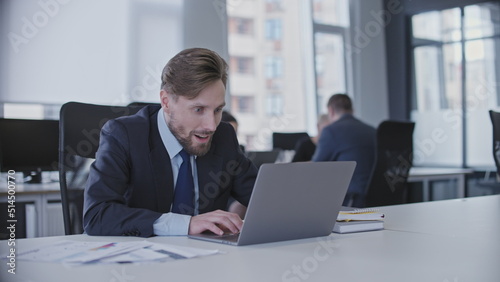 Bad employee playing computer game instead of working in the office, procrastination