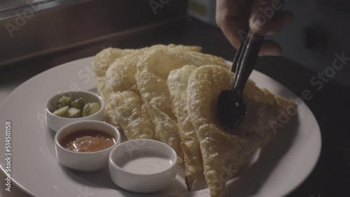 slow motion frying pies in hot oil and serving on a plate