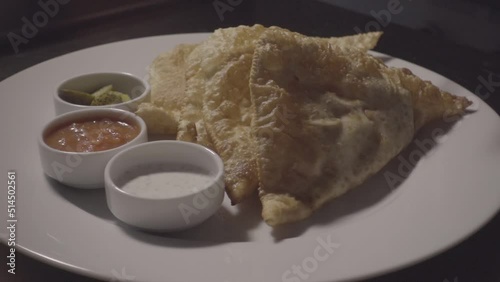 slow motion frying pies in hot oil and serving on a plate