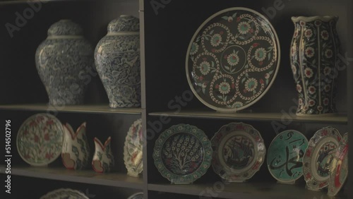 plates displayed in the window of a shop selling handmade ornamental plates