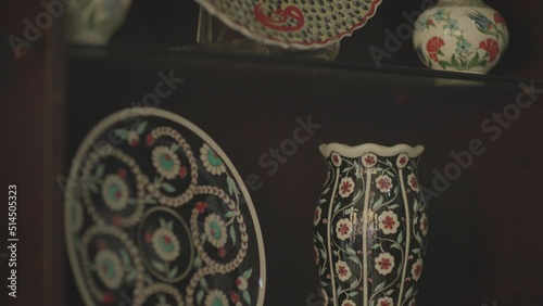 plates displayed in the window of a shop selling handmade ornamental plates