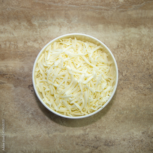 A bowl with shredded Oaxaca cheese. photo