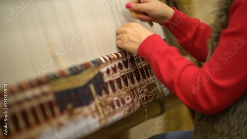 woman weaving a handmade carpet close-up