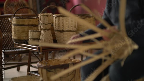 male worker weaving wicker baskets in the workshop where handmade wicker baskets are produced