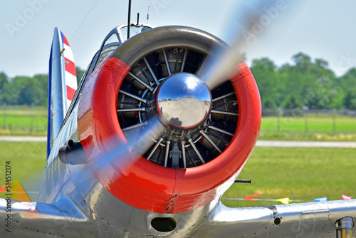 An closeup of a running airplane engine as the plane taxis across the tarmac.