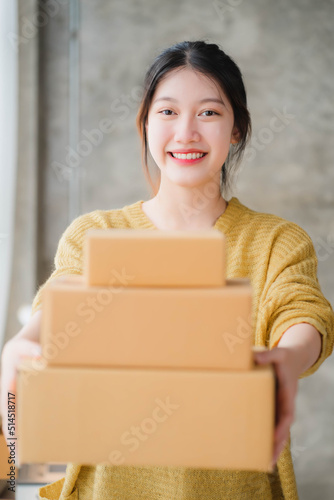 Asian SME business women use laptop computer checking customer order online shipping boxes at home. Starting Small business entrepreneur SME freelance. Online business, Work at home concept © Kritdanai