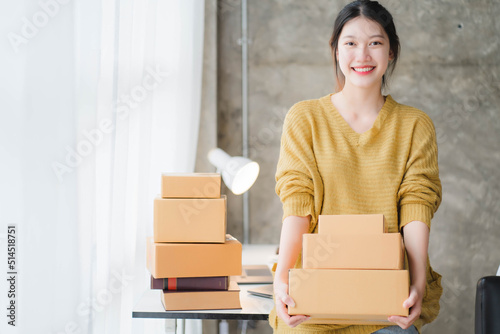 Asian SME business women use laptop computer checking customer order online shipping boxes at home. Starting Small business entrepreneur SME freelance. Online business, Work at home concept