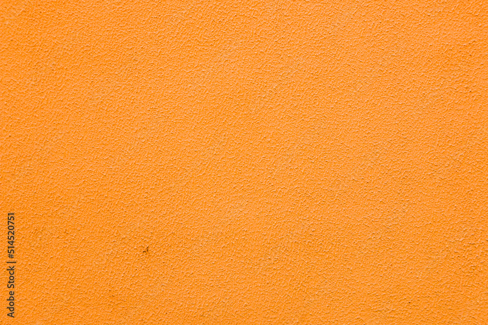 Fototapeta premium A wall with worn orange plaster.