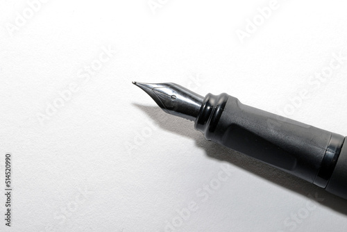 fountain pen on a blank white paper background