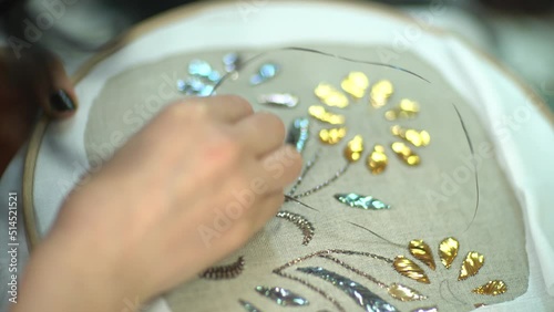Close-up video shoot of a woman who does handicraft embroidery and the finished products she embroidered