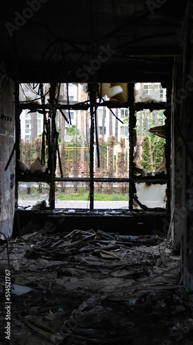 Irpin, Ukraine - May 22, 2022: view from the broken window of a burned room of a house bombed by the Russian army
