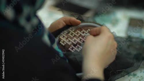 Close-up video shoot of a woman who does handicraft embroidery and the finished products she embroidered