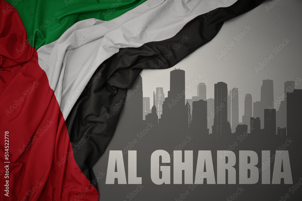 abstract silhouette of the city with text Al Gharbia near waving national flag of united arab emirates on a gray background.