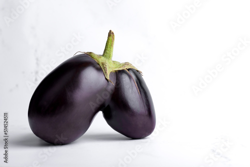 Trendy ugly eggplant isolated on concrete grey background, funny aubergine vegetables for a healthy diet with copy space, Funny, unnormal vegetable concept photo