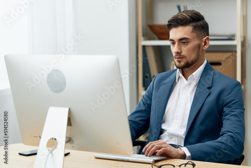 handsome businessman sitting at the computer work boss executive