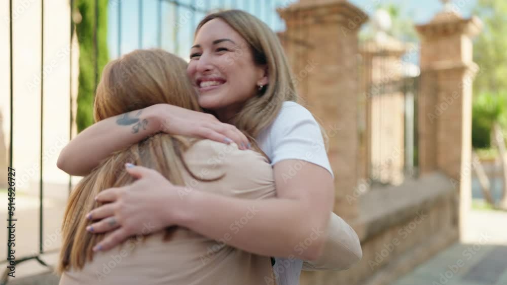 Mother and daughter smiling confident hugging each other at street Mother and daughter smiling confident hugging each other at street