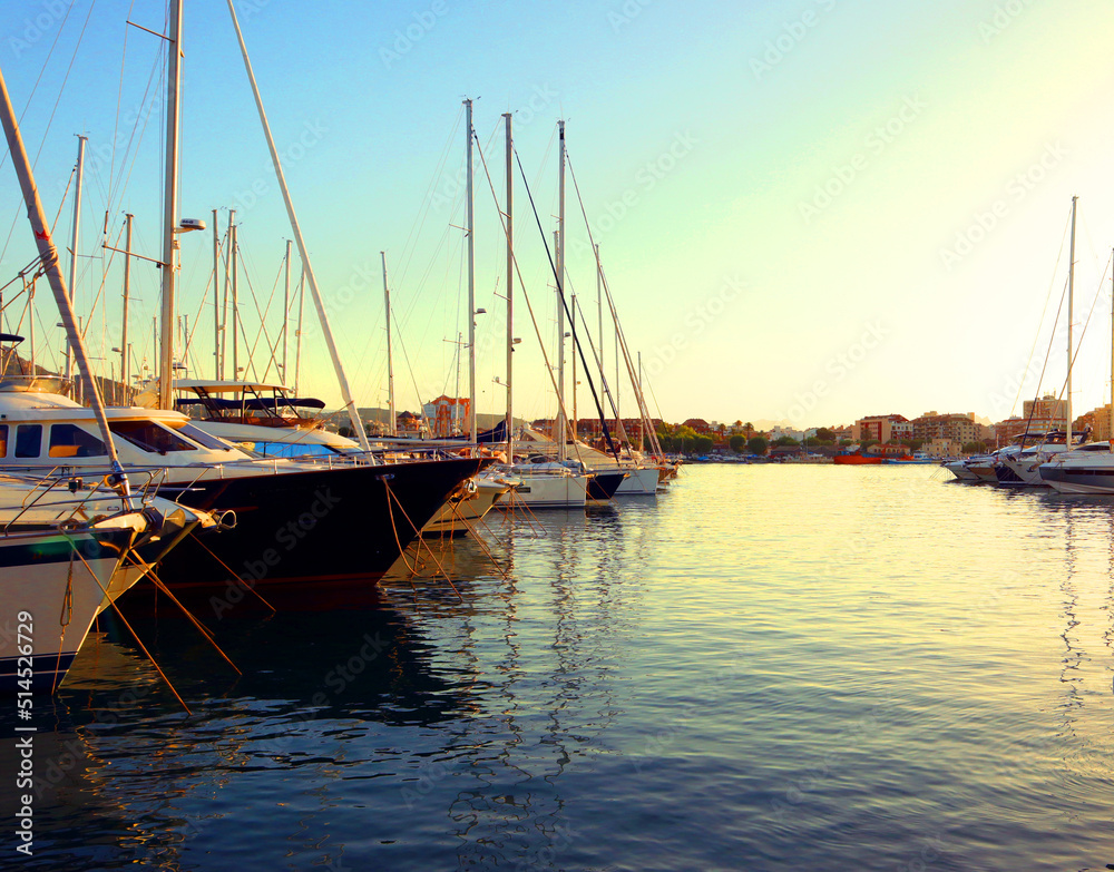 Seaport, many different yachts, sea, sunset, city in the distance, sports port, Denia, Spain