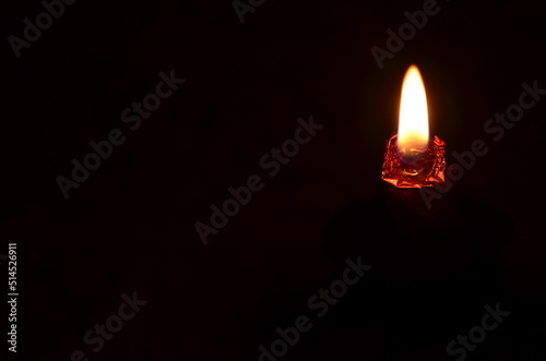 candle flame on a black background as a symbol of grief