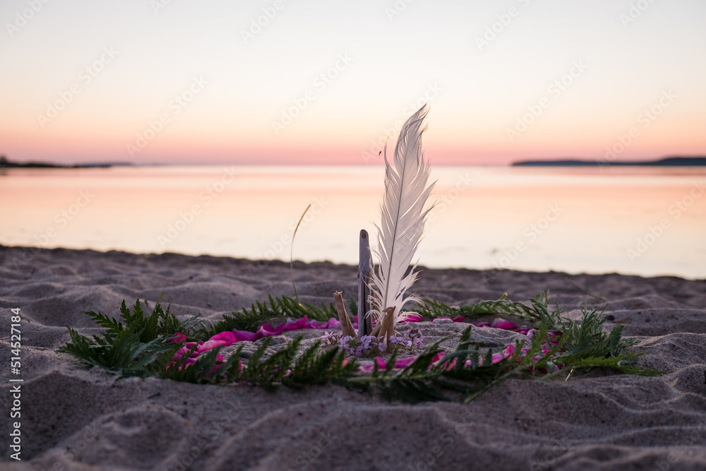 Mandala on ground. Making a mandala of natural elements on a beach