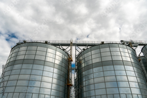 A large modern plant for the storage and processing of grain crops. view of the granary on a sunny day against the blue sky. End of harvest season.