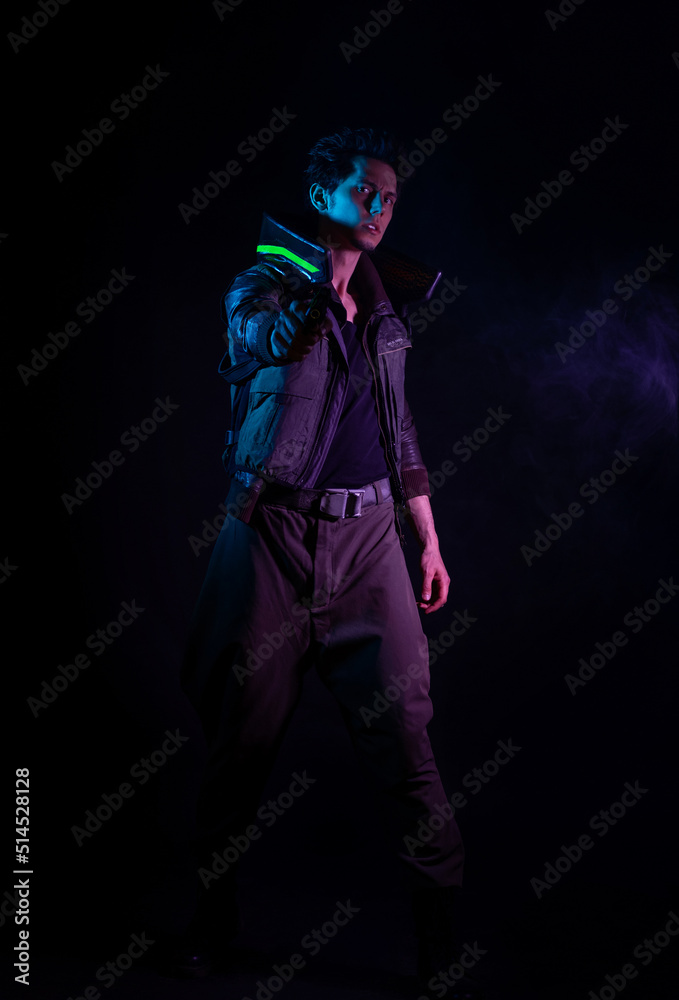 A guy in a cyberpunk image, aiming a gun at someone. a futuristic character. A young man in neon lighting on a black background