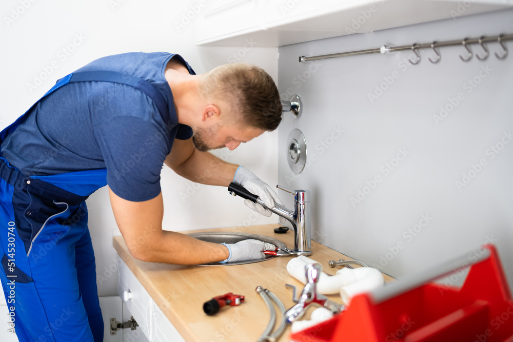 Plumber Fixing Faucet In Kitchen Plumber Fixing Faucet In Kitchen