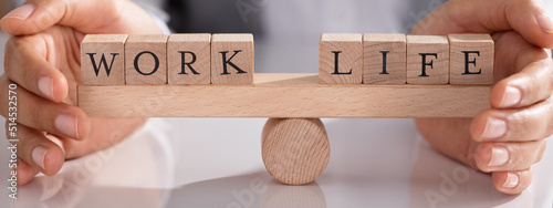 Businessperson Protecting Life And Work On Wooden Seesaw photo