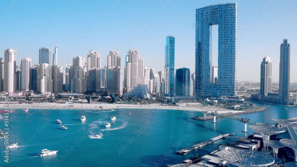 Famous Address Beach Resort with Jumeirah beach residences along with tourists in Dubai, UAE. Beautiful Marina bay district.