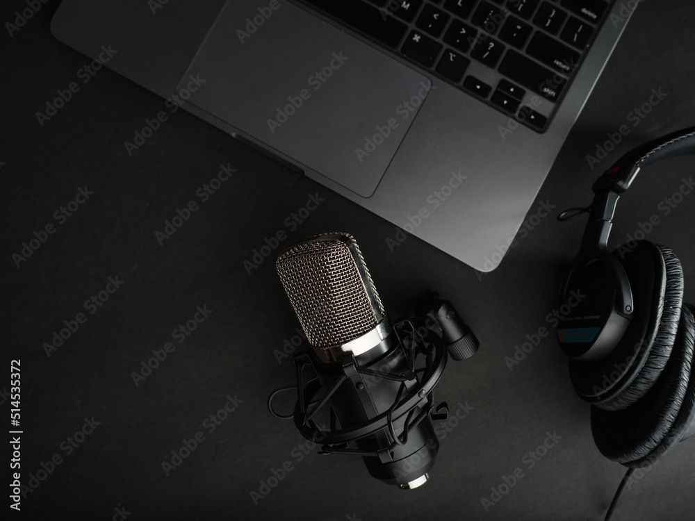Fotografie Studio headphones, studio microphone and laptop on a gray background