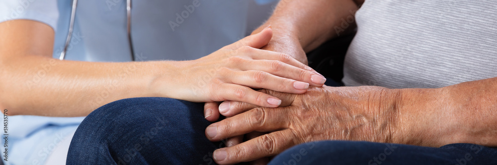 Fototapeta premium Senior Man Sitting On Wheelchair With Female Nurse