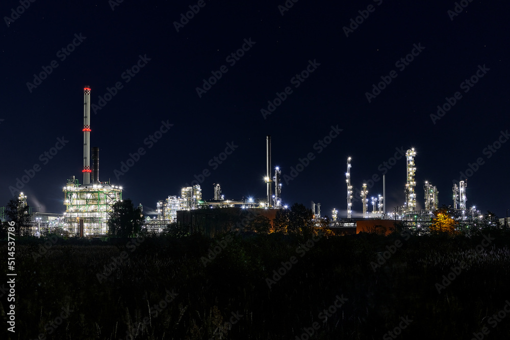 night time silhouette of oil refinery PCK Schwedt producing fuel from russian oil pipe druschba