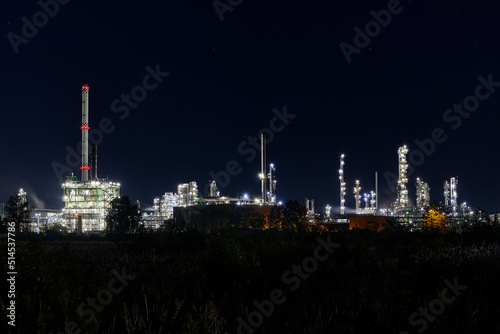 night time silhouette of oil refinery PCK Schwedt producing fuel from russian oil pipe druschba