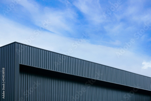 Valokuvatapetti Metal sheet building modern with vivid sky