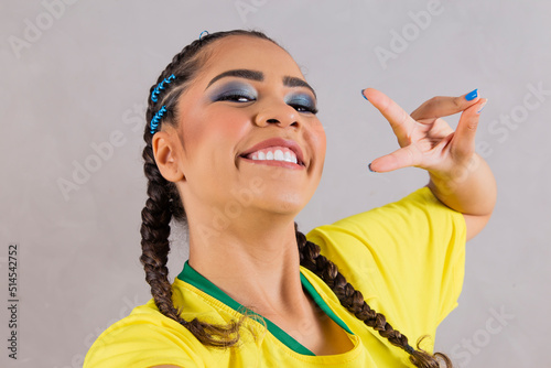 Brazil supporter. Brazilian woman fan celebrating on soccer, football match on background. Brazil colors. Selfie smartphone.