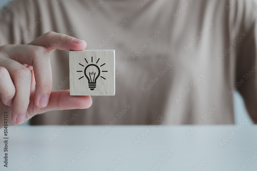 Inspiration, brainstorming creative ideas for new innovations. Hand holding creative light bulb icons on wood cube, analysis solution and development, Modern business, Innovative of new ideas. Inspiration, brainstorming creative ideas for new innovations. Hand holding creative light bulb icons on wood cube, analysis solution and development, Modern business, Innovative of new ideas.