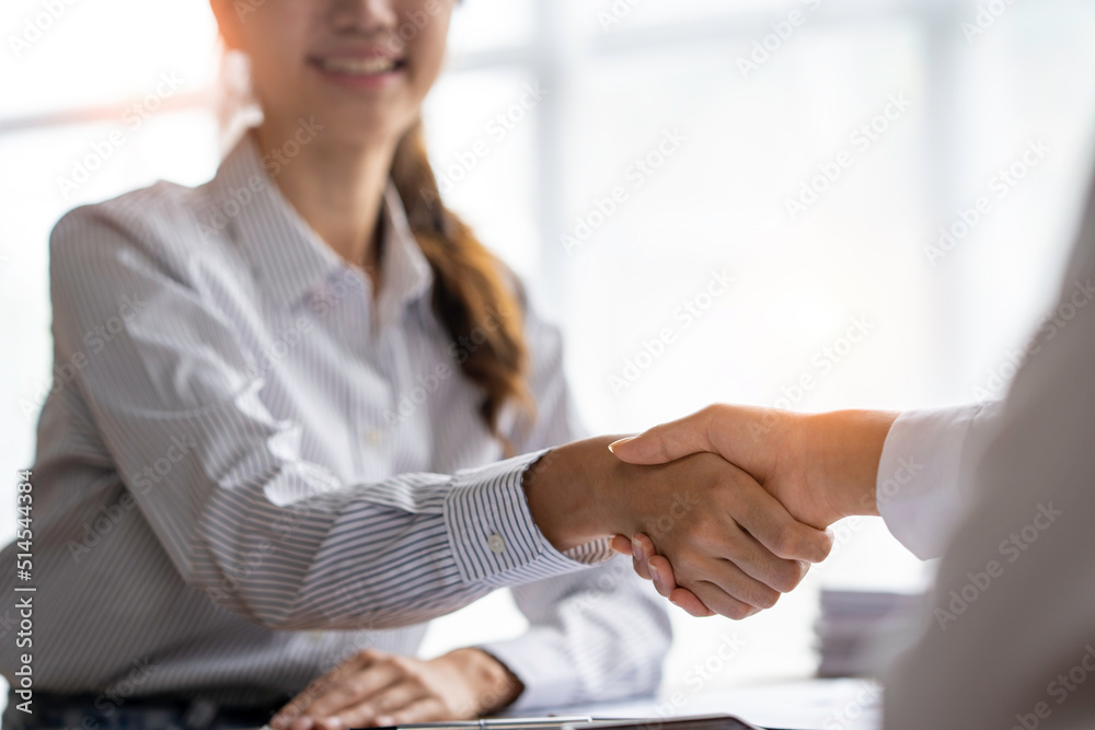 Young businesspeople shaking hands in the office, Finishing successful meetings, a handshake of business people deal business, Teamwork Young businesspeople shaking hands in the office, Finishing successful meetings, a handshake of business people deal business, Teamwork