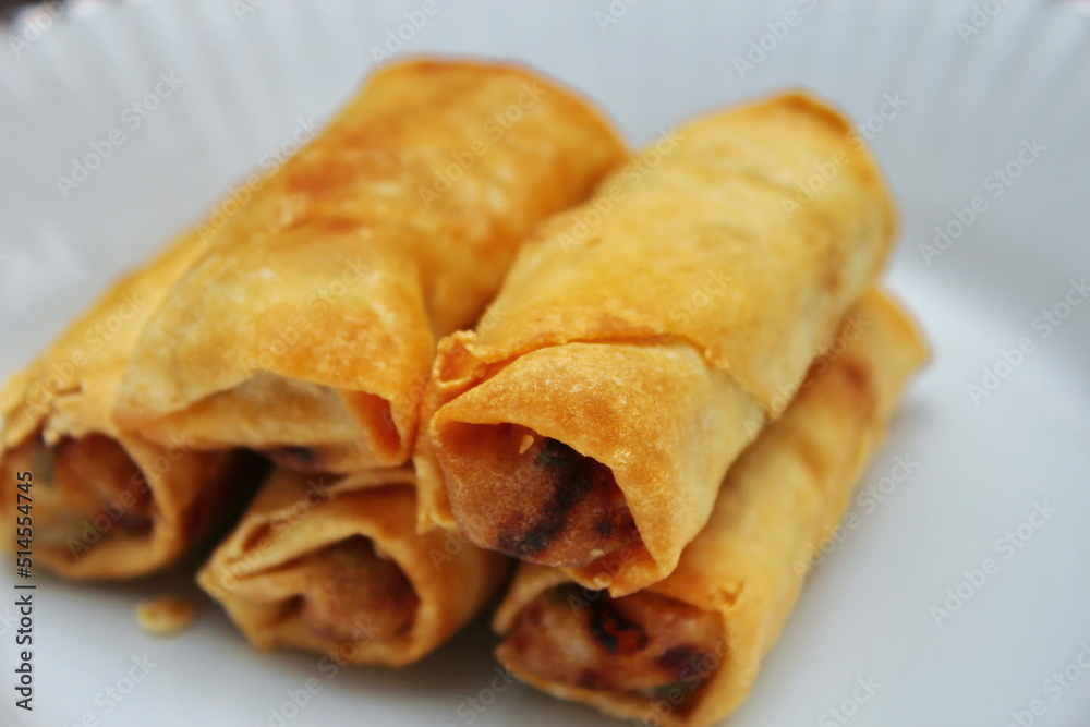 Fried spring rolls placed in a white plate, fried spring rolls are a popular Asian dish. Fried spring rolls placed in a white plate, fried spring rolls are a popular Asian dish.