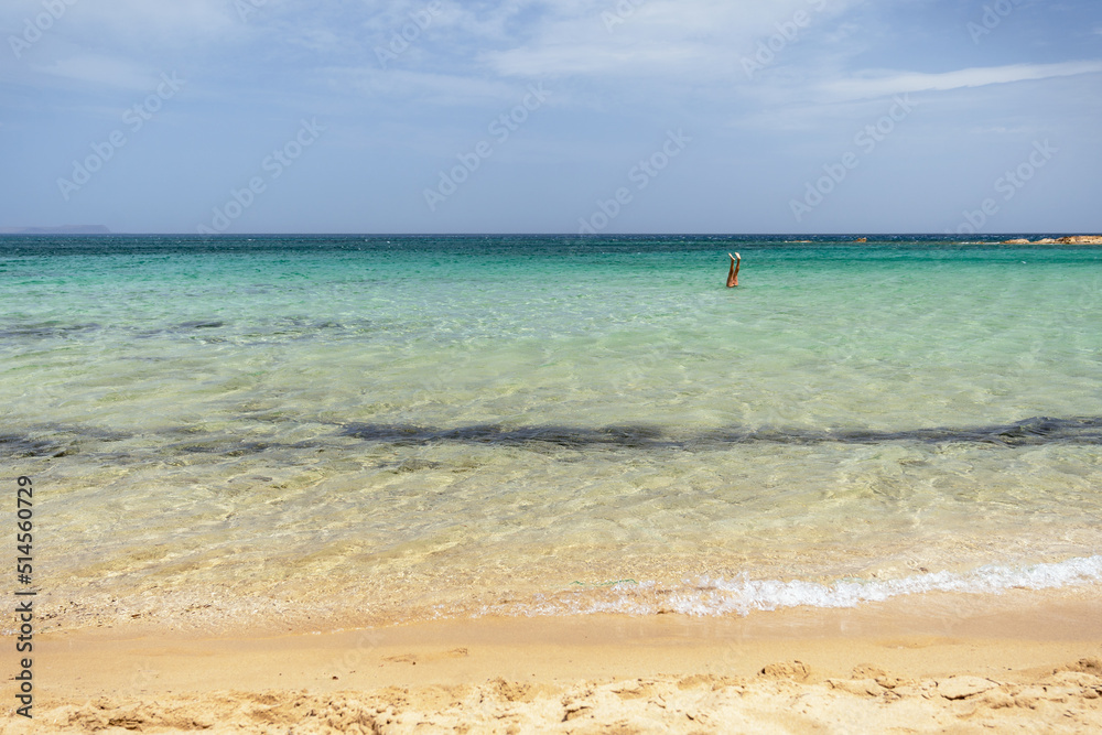 Wonderful holidays in Crete – woman, girl swimming, fun playing underwater upside down. Nisos beach in Malia, northern coast of the Greek island of Crete., Wonderful holidays in Crete – woman, girl swimming, fun playing underwater upside down. Nisos beach in Malia, northern coast of the Greek island of Crete.,