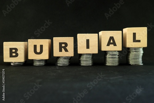 High price and costly funeral and burial cost concept. Increasing stack of coins in dark black background.