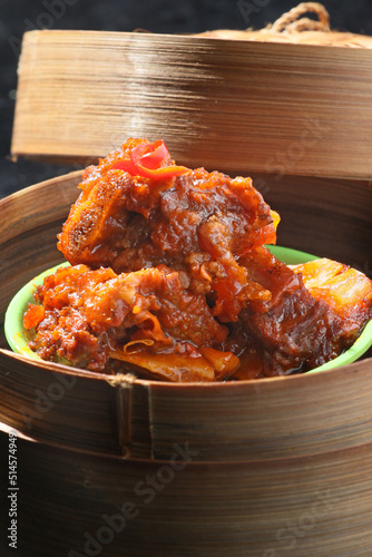 Dimsum, spicy beef ribs. Served on a bamboo bowl and container. blur background