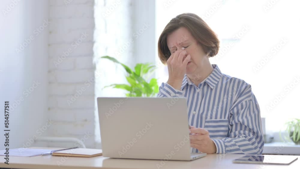Tired Senior Woman Rubbing Eyes at Work Tired Senior Woman Rubbing Eyes at Work