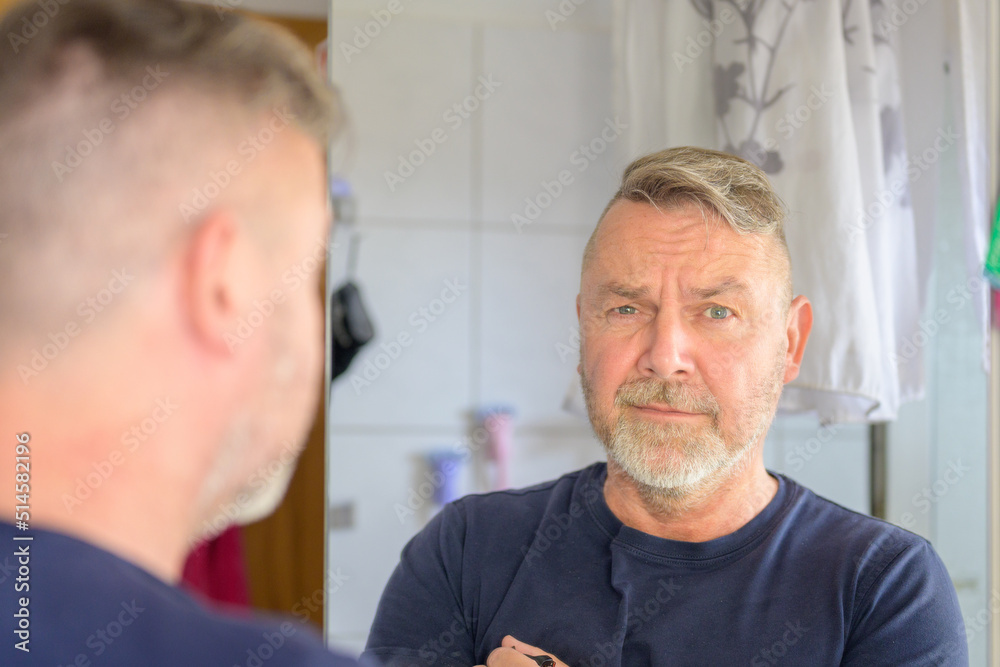Middle-aged man giving the camera an anguished look Middle-aged man giving the camera an anguished look