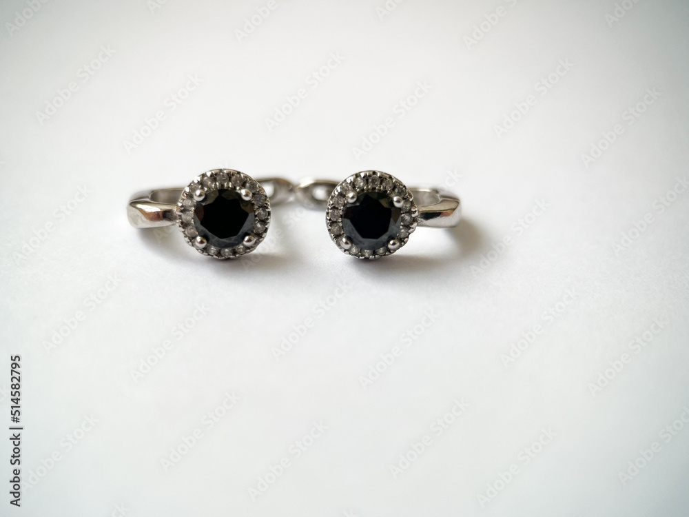 Silver earrings with black zircon close-up