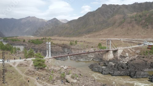 Bridge over the stormy Katun River in the Altai Mountains