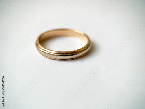 Gold wedding ring on a white isolated background. Red and white gold ring