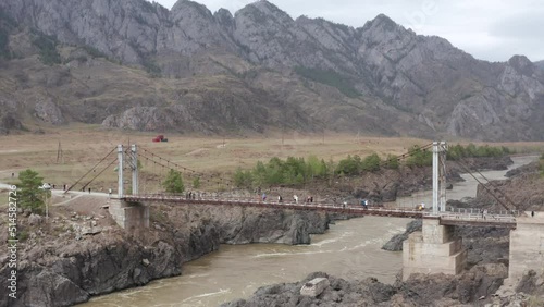 Bridge over the stormy Katun River in the Altai Mountains