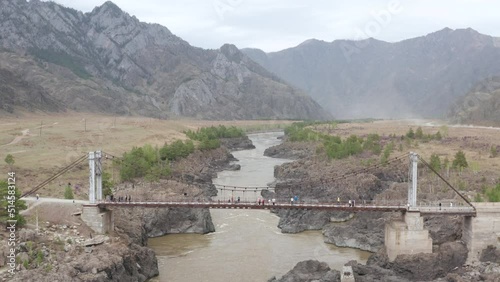 Bridge over the stormy Katun River in the Altai Mountains