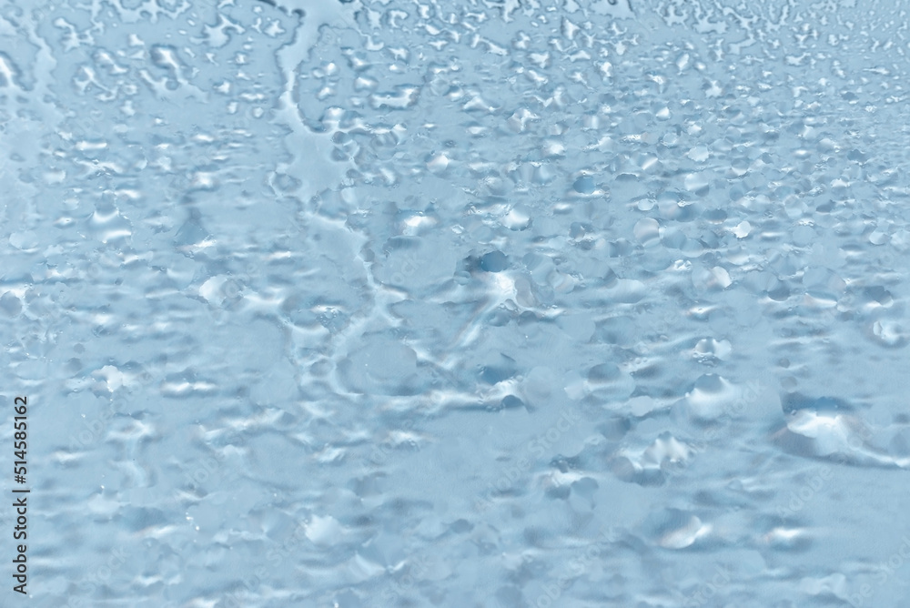 Water drops condensate on white background texture on transparent glass. backdrop glass covered with abstract drops of water.blurred image. Water drops condensate on white background texture on transparent glass. backdrop glass covered with abstract drops of water.blurred image.